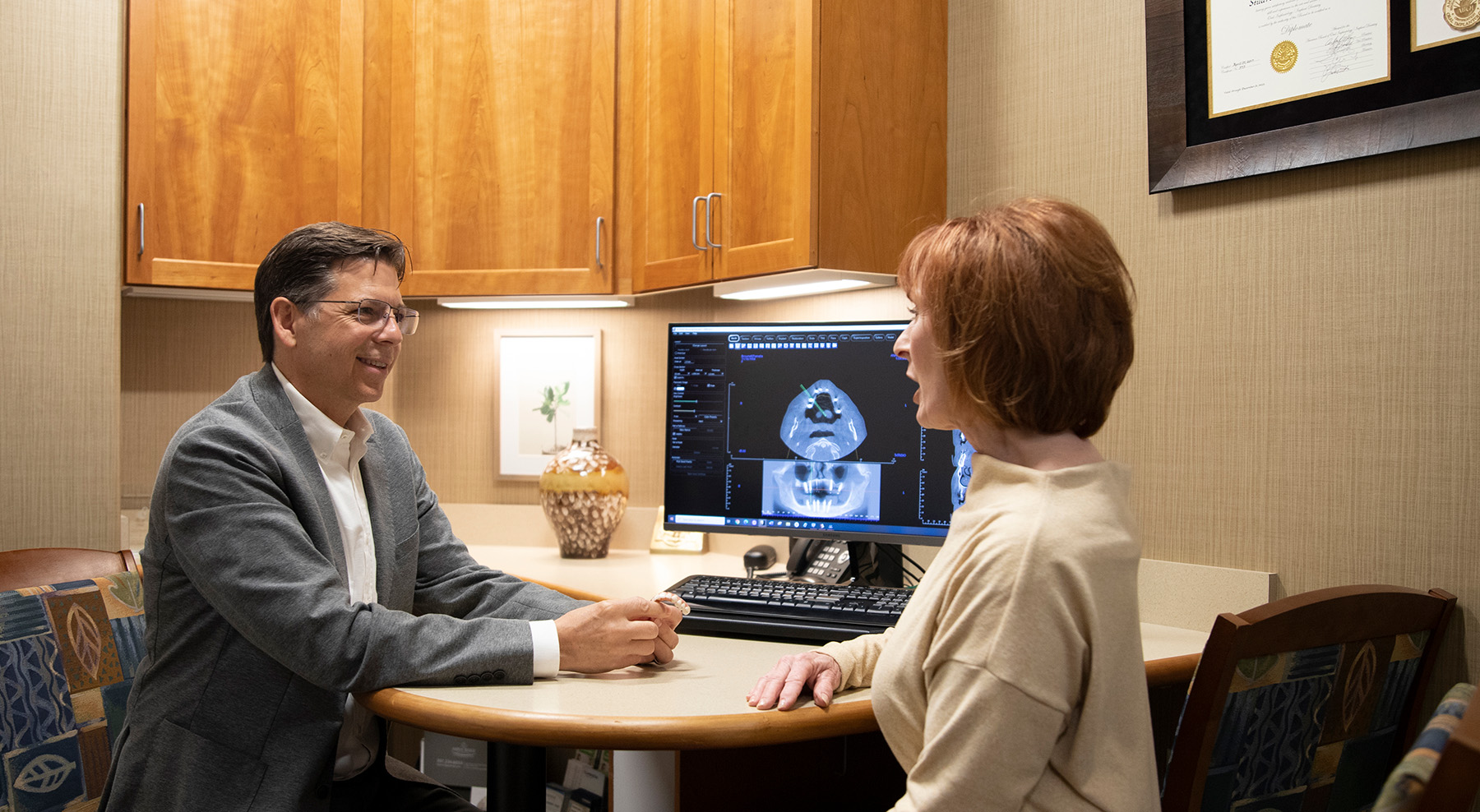 Dr. Youmans in consultation with an implant patient