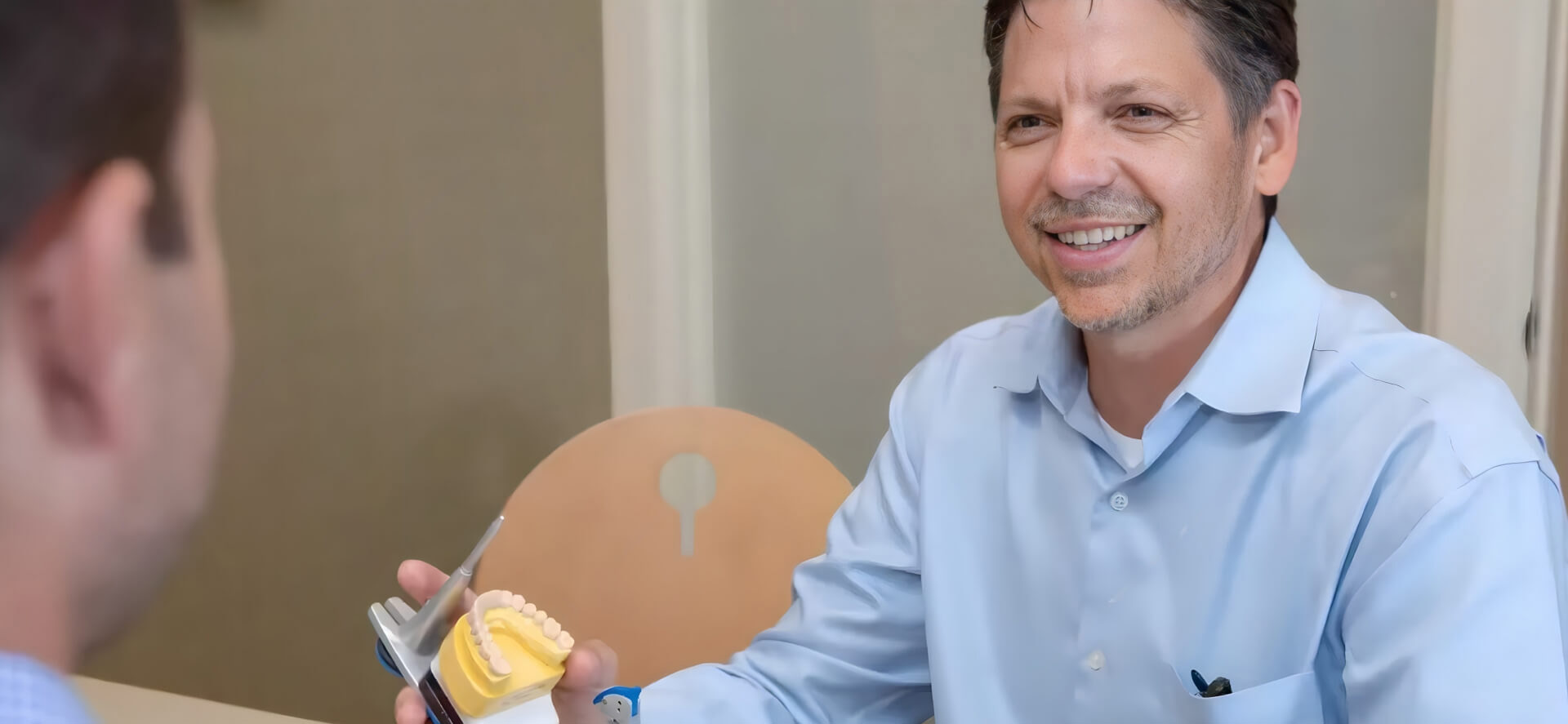 Dr. Youmans chairside with a full-mouth implant patient