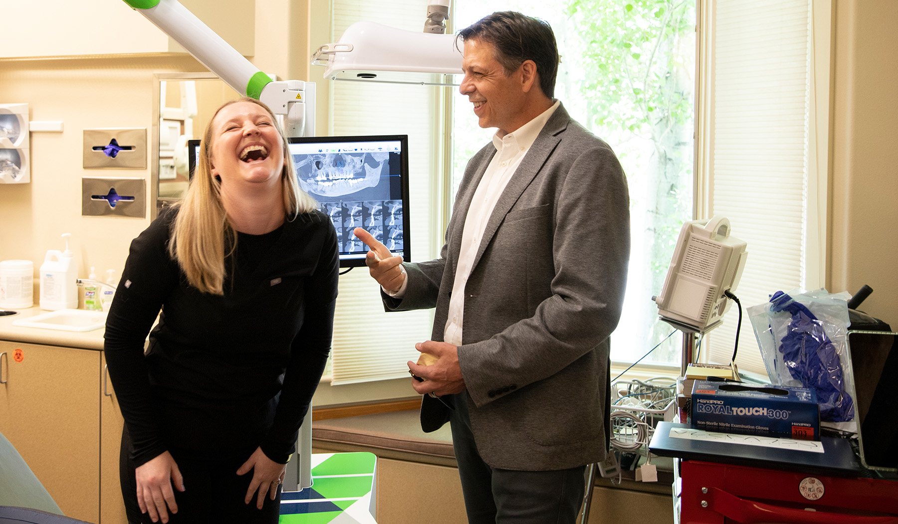 Dr. Youmans laughing with a team member between patients