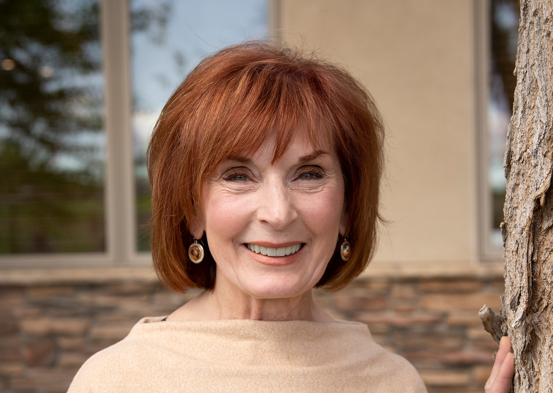 Wyo Dental Implants patient with red hair smiling outside the Casper office