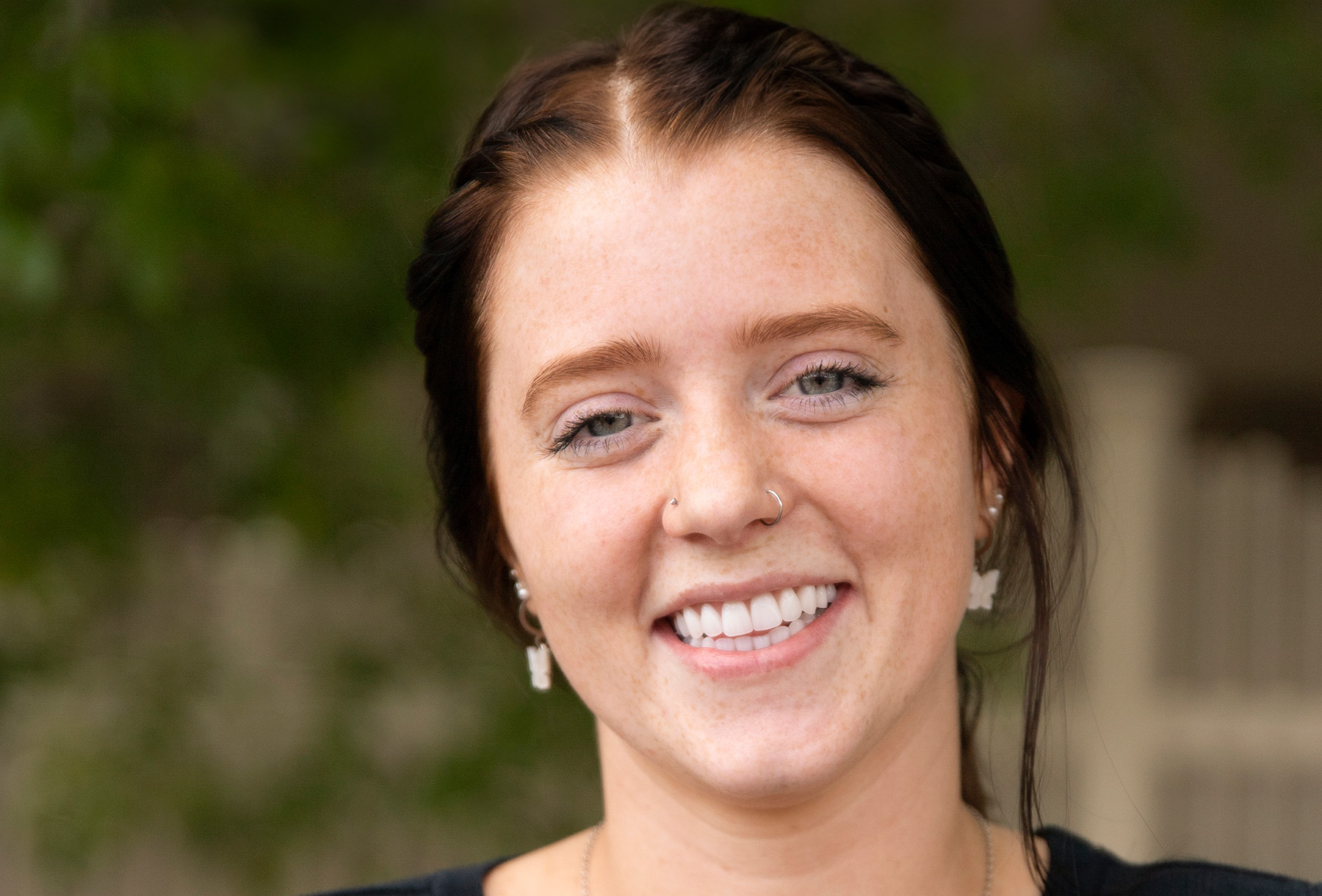Wyo Dental Implants patient with dark hair smiling in a close portrait