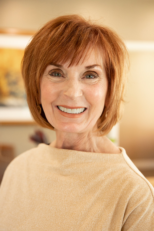 Smiling Wyo Dental Implants patient with her restored smile